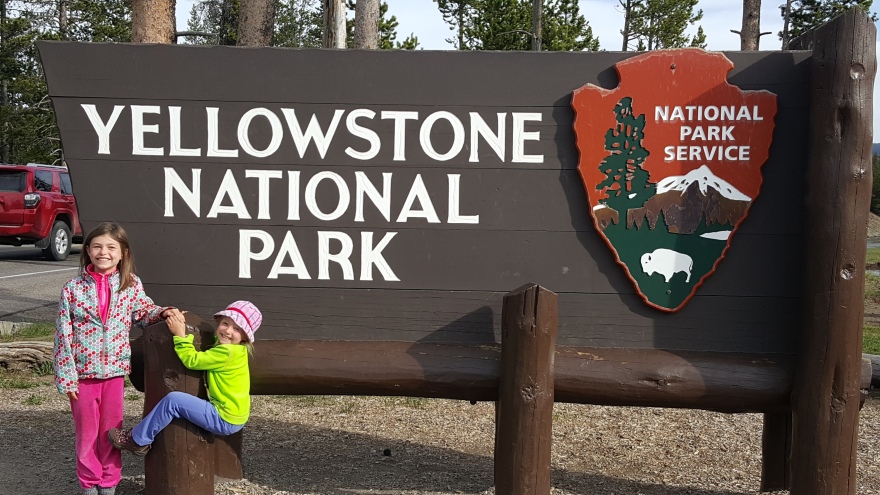 Yellowstone sign with kids